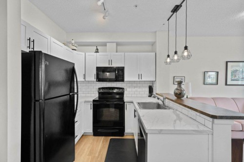 304-201 Sunset Drive, Cochrane, AB - Indoor Photo Showing Kitchen