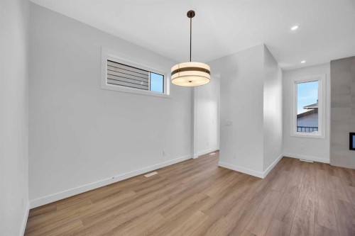 14 Versant Path Sw, Calgary, AB - Indoor Photo Showing Other Room With Fireplace