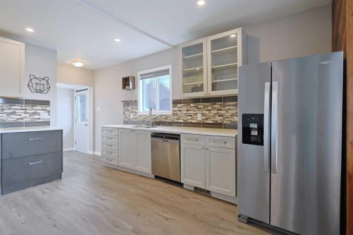 18 Maple Street, Okotoks, AB - Indoor Photo Showing Kitchen With Stainless Steel Kitchen With Upgraded Kitchen