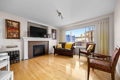 73 Sunset Heights, Cochrane, AB - Indoor Photo Showing Living Room With Fireplace