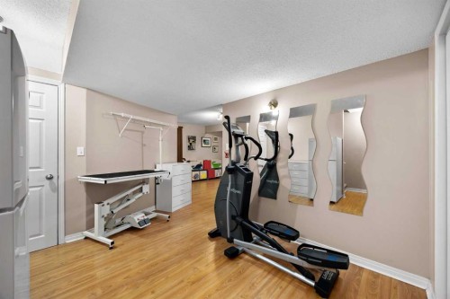 73 Sunset Heights, Cochrane, AB - Indoor Photo Showing Gym Room