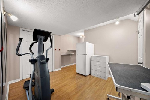 73 Sunset Heights, Cochrane, AB - Indoor Photo Showing Gym Room