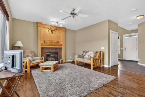 55 Sheep River Cove, Okotoks, AB - Indoor With Fireplace