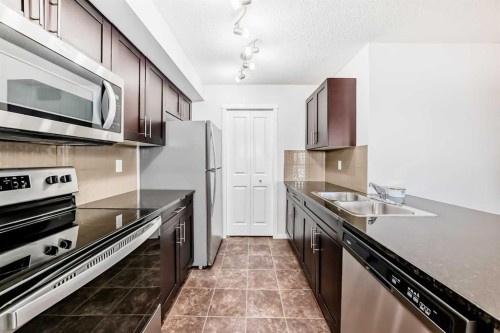 2324-81 Legacy Boulevard Se, Calgary, AB - Indoor Photo Showing Kitchen With Stainless Steel Kitchen With Double Sink With Upgraded Kitchen