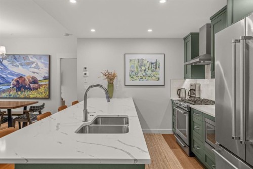 313-1408 Spring Creek Gate, Canmore, AB - Indoor Photo Showing Kitchen With Stainless Steel Kitchen With Double Sink With Upgraded Kitchen