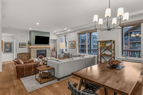 313-1408 Spring Creek Gate, Canmore, AB - Indoor Photo Showing Living Room With Fireplace