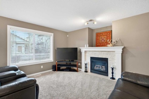 69 Elkton Way Sw, Calgary, AB - Indoor Photo Showing Living Room With Fireplace