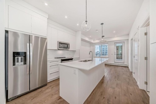 4416-6 Merganser Drive West, Chestermere, AB - Indoor Photo Showing Kitchen With Double Sink With Upgraded Kitchen