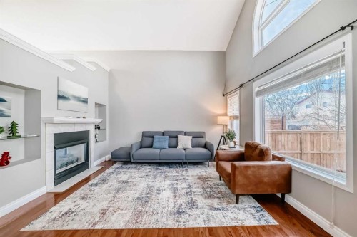 188 Hidden Ranch Crescent Nw, Calgary, AB - Indoor Photo Showing Living Room With Fireplace