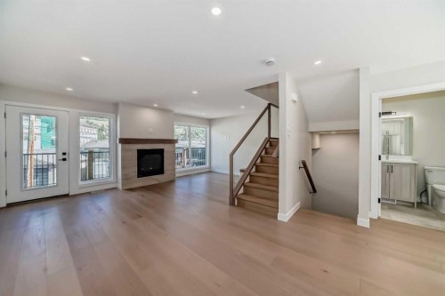 115-1330 1St Avenue, Canmore, AB - Indoor Photo Showing Living Room With Fireplace