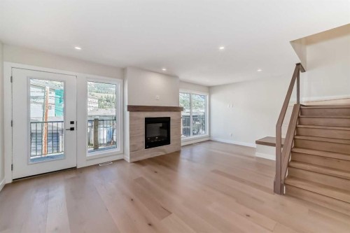 115-1330 1St Avenue, Canmore, AB - Indoor Photo Showing Living Room With Fireplace