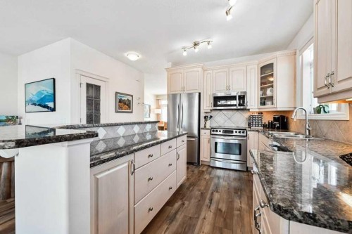 56 Discovery Woods Villas Sw, Calgary, AB - Indoor Photo Showing Kitchen With Stainless Steel Kitchen With Double Sink With Upgraded Kitchen