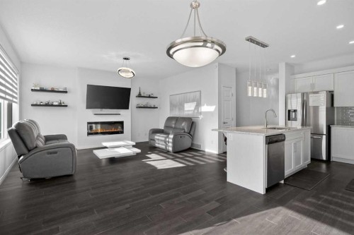 82 Osborne Common Sw, Airdrie, AB - Indoor Photo Showing Kitchen With Fireplace With Upgraded Kitchen