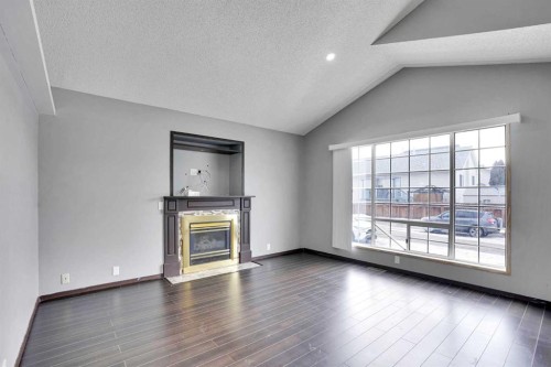 131 Martinridge Grove Ne, Calgary, AB - Indoor Photo Showing Living Room With Fireplace