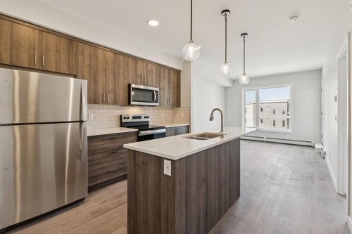412-700 Shawnee Square Sw, Calgary, AB - Indoor Photo Showing Kitchen With Stainless Steel Kitchen With Double Sink With Upgraded Kitchen