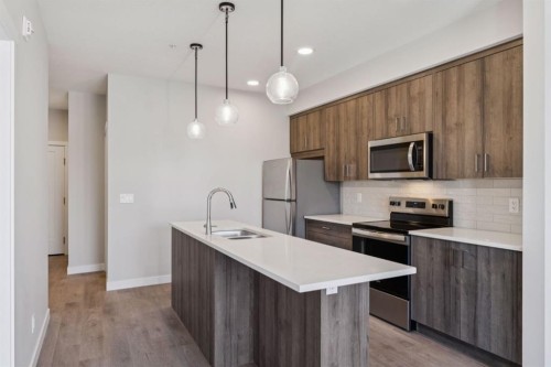 412-700 Shawnee Square Sw, Calgary, AB - Indoor Photo Showing Kitchen With Stainless Steel Kitchen With Double Sink With Upgraded Kitchen
