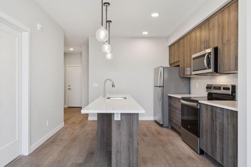 412-700 Shawnee Square Sw, Calgary, AB - Indoor Photo Showing Kitchen With Stainless Steel Kitchen With Upgraded Kitchen