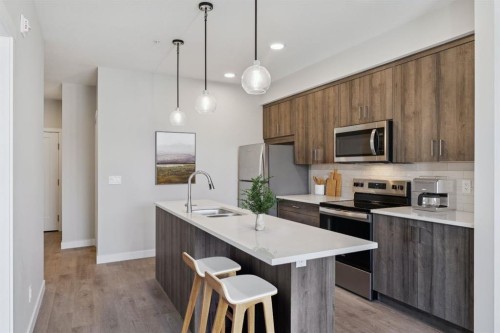 412-700 Shawnee Square Sw, Calgary, AB - Indoor Photo Showing Kitchen With Stainless Steel Kitchen With Double Sink With Upgraded Kitchen