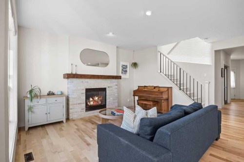 59 Cortina Way Sw, Calgary, AB - Indoor Photo Showing Living Room With Fireplace
