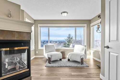 208 Tuscany Ravine View Nw, Calgary, AB - Indoor Photo Showing Living Room With Fireplace