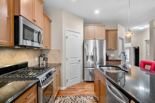 223 Sunset Square, Cochrane, AB - Indoor Photo Showing Living Room With Fireplace
