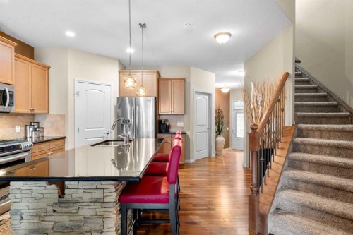 223 Sunset Square, Cochrane, AB - Indoor Photo Showing Living Room With Fireplace