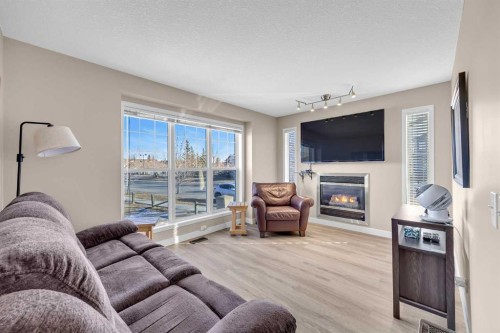 71 Eversyde Heath Sw, Calgary, AB - Indoor Photo Showing Living Room With Fireplace