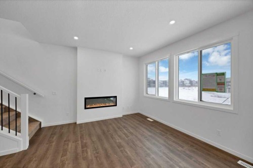 569 Chelsea Gardens, Chestermere, AB - Indoor Photo Showing Other Room With Fireplace