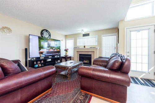 84 Tarington Way Ne, Calgary, AB - Indoor Photo Showing Living Room With Fireplace