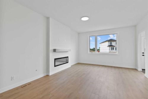 175 Belvedere Crescent Se, Calgary, AB - Indoor Photo Showing Living Room With Fireplace