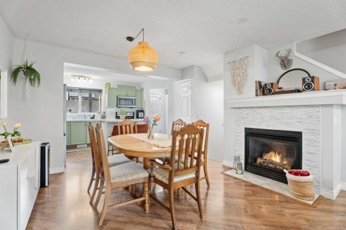 242 Elgin Place Se, Calgary, AB - Indoor Photo Showing Dining Room With Fireplace