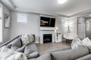22 Osborne Common Sw, Airdrie, AB  - Indoor Photo Showing Living Room With Fireplace 