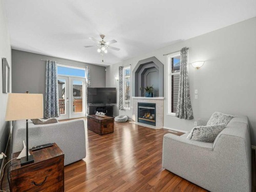 106 Springs Place Se, Airdrie, AB - Indoor Photo Showing Living Room With Fireplace