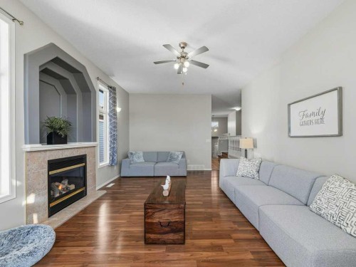 106 Springs Place Se, Airdrie, AB - Indoor Photo Showing Living Room With Fireplace
