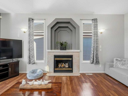 106 Springs Place Se, Airdrie, AB - Indoor Photo Showing Living Room With Fireplace