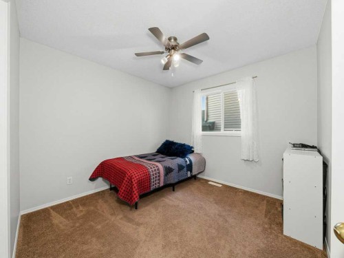 106 Springs Place Se, Airdrie, AB - Indoor Photo Showing Bedroom