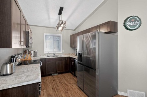 107 Mt Allan Circle Se, Calgary, AB - Indoor Photo Showing Kitchen With Double Sink