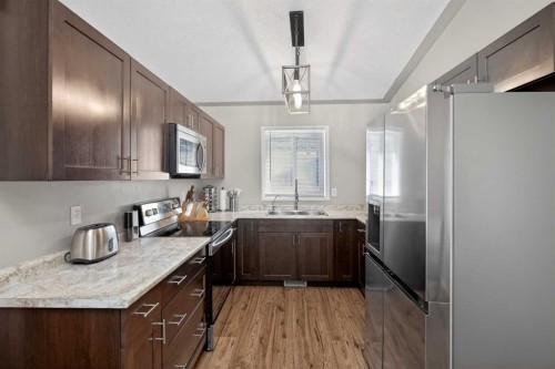 107 Mt Allan Circle Se, Calgary, AB - Indoor Photo Showing Kitchen With Double Sink
