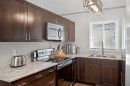 107 Mt Allan Circle Se, Calgary, AB  - Indoor Photo Showing Kitchen With Double Sink 