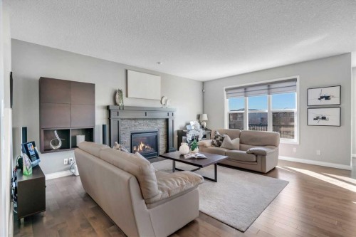 53 Sundown Grove, Cochrane, AB - Indoor Photo Showing Living Room With Fireplace