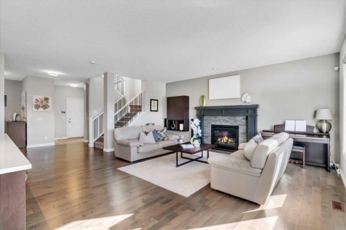 53 Sundown Grove, Cochrane, AB - Indoor Photo Showing Living Room With Fireplace