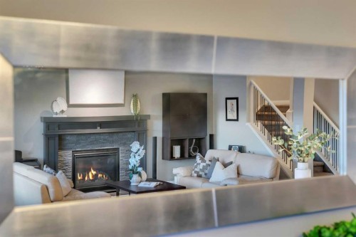 53 Sundown Grove, Cochrane, AB - Indoor Photo Showing Living Room With Fireplace