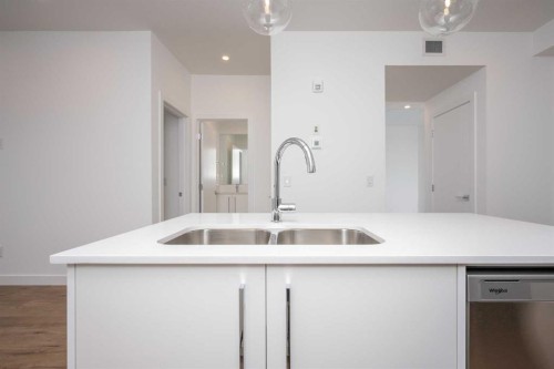 1406-111 Wolf Creek Drive Se, Calgary, AB - Indoor Photo Showing Kitchen With Double Sink