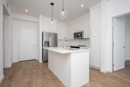 1406-111 Wolf Creek Drive Se, Calgary, AB - Indoor Photo Showing Kitchen With Stainless Steel Kitchen With Upgraded Kitchen