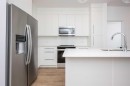 1406-111 Wolf Creek Drive Se, Calgary, AB  - Indoor Photo Showing Kitchen With Stainless Steel Kitchen With Upgraded Kitchen 