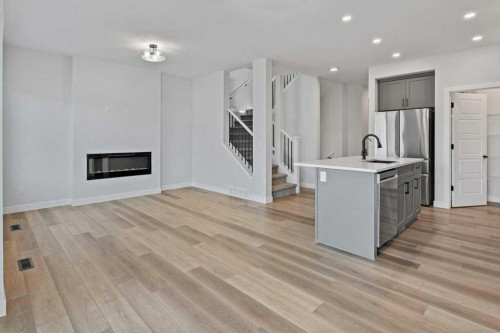 71 Ranchers View, Okotoks, AB - Indoor Photo Showing Kitchen With Fireplace With Upgraded Kitchen