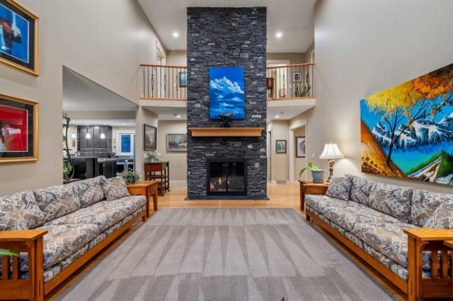 39 Echlin Drive, Bragg Creek, AB - Indoor Photo Showing Living Room With Fireplace