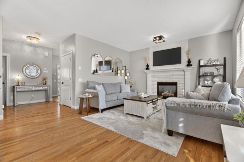 208 Cimarron Drive, Okotoks, AB - Indoor Photo Showing Living Room With Fireplace