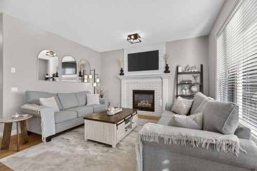 208 Cimarron Drive, Okotoks, AB - Indoor Photo Showing Living Room With Fireplace