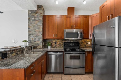 20-117 Rockyledge View Nw, Calgary, AB - Indoor Photo Showing Kitchen With Stainless Steel Kitchen With Double Sink